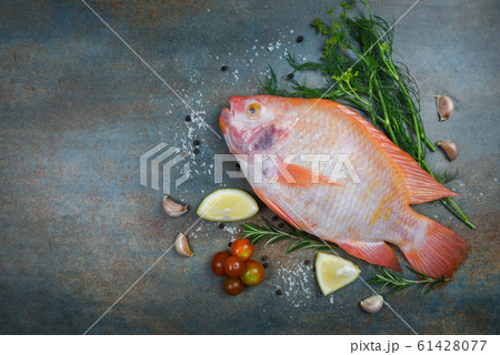 Fresh fish with herbs spices rosemary and lemon 61428077