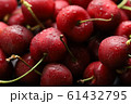 Bright red cherries covered with water droplets. Photos from above, the red background. 61432795