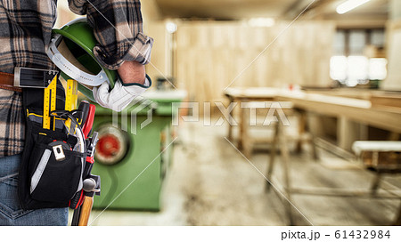 Carpenter in the carpentry workshop. Craft work. 61432984
