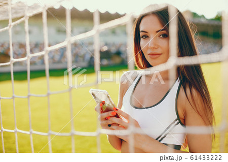 Sports girl training at the stadium 61433222