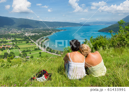 Two women watching  view of Lake Annecy 61433991