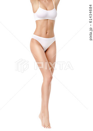 Slim woman's legs isolated on white background Slim woman's legs isolated on white background 61434684