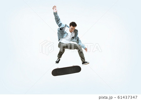 Caucasian young skateboarder riding isolated on a white background 61437347