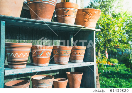 Vintage clay pots with ornamental pattern standing 61439320