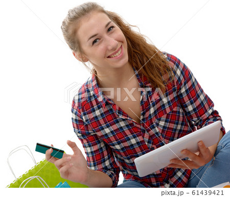 Cheerful woman holding credit cards for shopping Cheerful woman holding credit cards for shopping 61439421