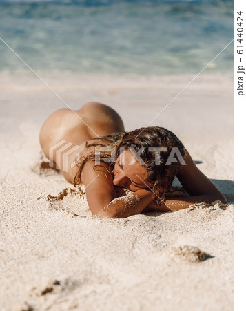 young naked on beach PIXTA