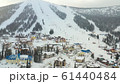 Mounting skiing resort. People skiing and snowboarding from the mountain.Beautiful view from above 61440484