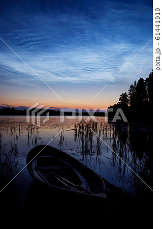 Night shining clouds over lake 61441919