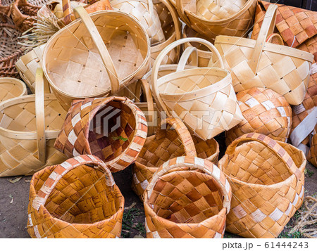A bunch of wicker baskets in retro style. Heap of birch baskets. Pile of birch bark bast baskets. 61444243