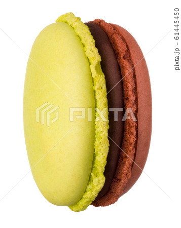 Macro photo of french caramel and pistachio macaroon isolated on white Macro photo of french caramel and pistachio macaroon isolated on white 61445450
