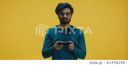 Young man playing video game 61448299