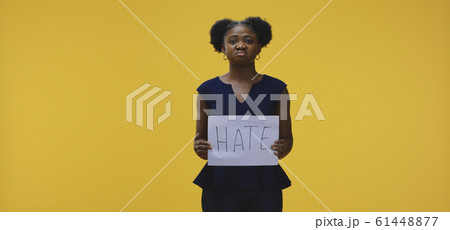 Woman holding hate sign 61448877