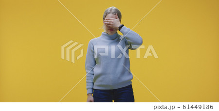 Woman covering her eyes 61449186