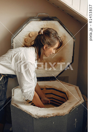 A young woman makes dishes in a pottery A young woman makes dishes in a pottery 61453837