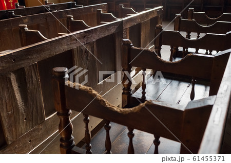 Rows of Church benches with sunlight close-up. Rows of Church benches with sunlight close-up. 61455371