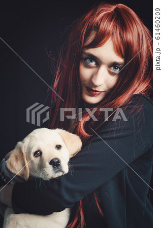 Young woman with her labrador retriever dog on a Young woman with her labrador retriever dog on a 61460209