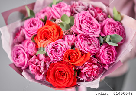 European floral shop. Beautiful bouquet of mixed flowers in womans hands. the work of the florist at a flower shop. Delivery fresh cut flower. European floral shop. Beautiful bouquet of mixed flowers in womans hands. the work of the florist at a flower shop. Delivery fresh cut flower. 61460648
