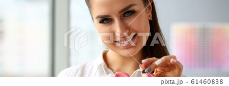 Happy beautiful woman put silver quarter in slot portrait Happy beautiful woman put silver quarter in slot portrait 61460838