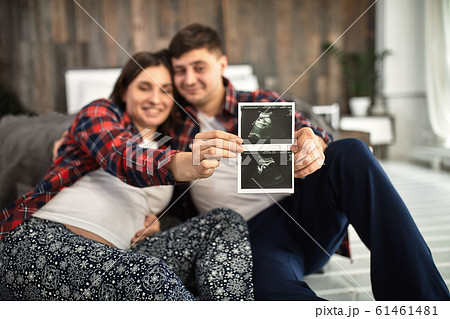 Beautiful pregnant couple in the bedroom. Preparing for childbirth, happy parents, waiting for the first child. Support for women before childbirth. Beautiful pregnant couple in the bedroom. Preparing for childbirth, happy parents, waiting for the first child. Support for women before childbirth. 61461481