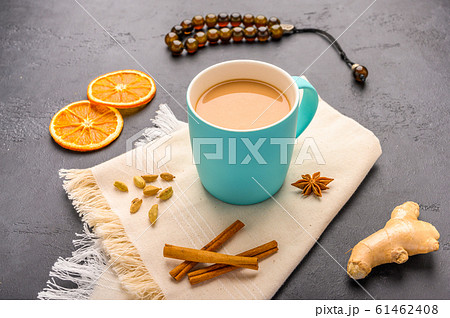 Traditional Indian masala tea chai with milk and spices on napkin on dark stone background with 61462408