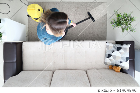 Woman cleaning carpet with vacuum cleaner at home 61464846