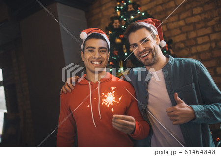 Happy delighted friends celebrating New Year together 61464848