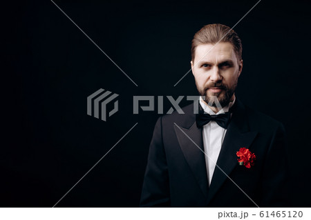 Handsome Brunet in Black Tie With a Carnation Boutonniere Handsome Brunet in Black Tie With a Carnation Boutonniere 61465120