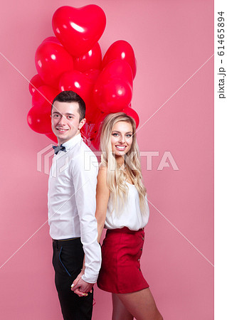 young loving couple with balloons heart on pink background 61465894