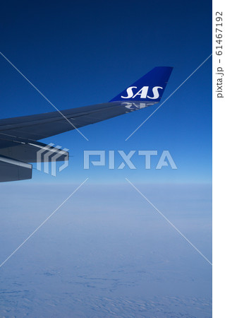 COPENHAGEN, DENMARK - NOV 24th, 2018: Wing of an airplane cruising above the clouds COPENHAGEN, DENMARK - NOV 24th, 2018: Wing of an airplane cruising above the clouds 61467192