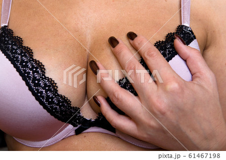 Bra and beautiful elastic natural female breasts close-up. 61467198