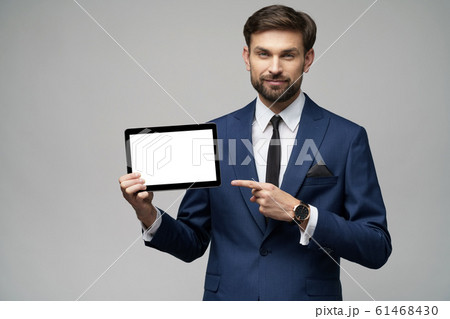 Young Businessman presenting digital tablet pc pad with blank screen Young Businessman presenting digital tablet pc pad with blank screen 61468430