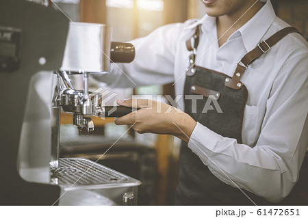 Male Barista preparing coffee for customer Male Barista preparing coffee for customer 61472651