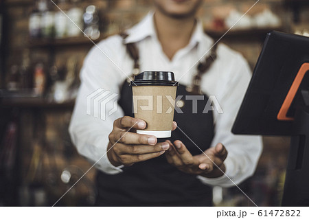 Male Barista preparing coffee for customer in coffee shop Male Barista preparing coffee for customer in coffee shop 61472822