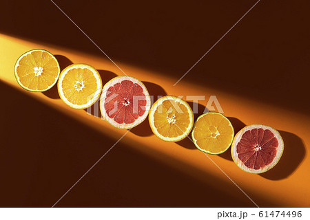 Sliced citrus fruits in sunlight. Halves of orange 61474496