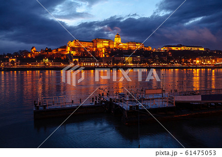 The Royal Palace of Budapest, Buda castle, in the evening with beautiful lighting on a background of clouds. The Royal Palace of Budapest, Buda castle, in the evening with beautiful lighting on a background of clouds. 61475053
