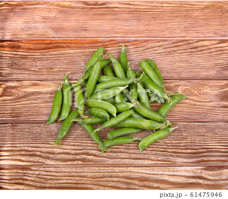 Green peas on wooden background.top view Green peas on wooden background.top view 61475946