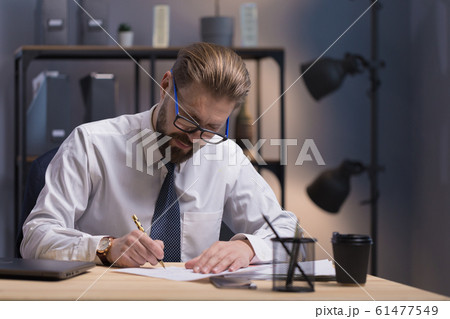 Concentrated Mature Bearded White Collar in Glasses Writing 61477549