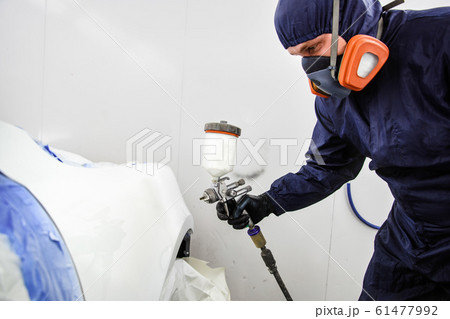 worker with spray gun in spray booth worker with spray gun in spray booth 61477992