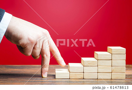 Businessman hand climbs career ladder of success. Going on a new level. Progress and professional growth. Appointment of an employee to a new position. Success, Self improvement skills and abilities 61478613