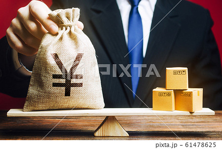 Pound sterling GBP symbol money bag and a bunch of boxes on scales. Trade exchange balance. Import and export, economic processes. Profit from manufactured goods. Manufacturing, retail distribution 61478625