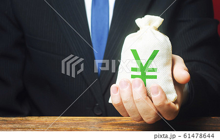 Man holds out a Yen yuan money bag. Provision of money on credit, grant. Project financing. Donations. Financial social assistance. Payment purchases, profits dividends. Business investment 61478644