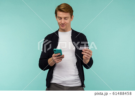 Cheerful sports red-haired guy conducts online Cheerful sports red-haired guy conducts online 61488458