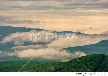 clouds rising above the hills 61490529
