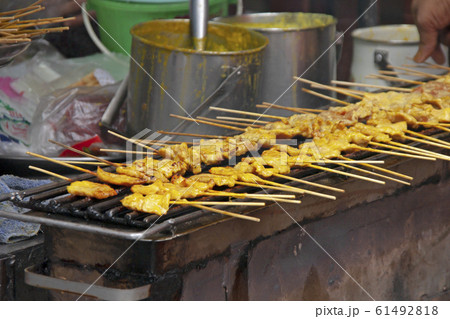 pork satay grill on hot stove,Pork satay is a street thai food ,light and delicious, suitable for snacks. pork satay grill on hot stove,Pork satay is a street thai food ,light and delicious, suitable for snacks. 61492818