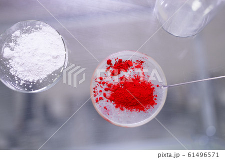 Two cups of petri dishes with red and white powder in laboratory 61496571