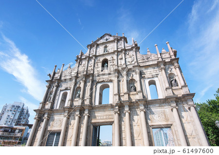 Macao, China - October 16, 2019: Front close up view of The Ruins of Saint Paul's (Ruinas de Sao Paulo) in Macau (Macao) city with blue sky, travel design concept. Macao, China - October 16, 2019: Front close up view of The Ruins of Saint Paul's (Ruinas de Sao Paulo) in Macau (Macao) city with blue sky, travel design concept. 61497600