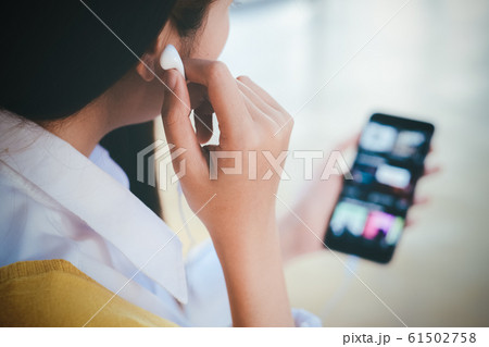 A young woman listen to online music from mobile 61502758