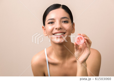 lips care and protection. smiling beautiful woman holding lip balm lips care and protection. smiling beautiful woman holding lip balm 61503060