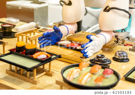 Sushi maker robots are serving food in future genius restaurants. 61503193