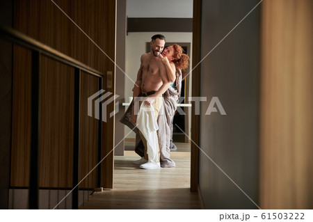 Happy pretty adult woman hugging man indoors Happy pretty adult woman hugging man indoors 61503222